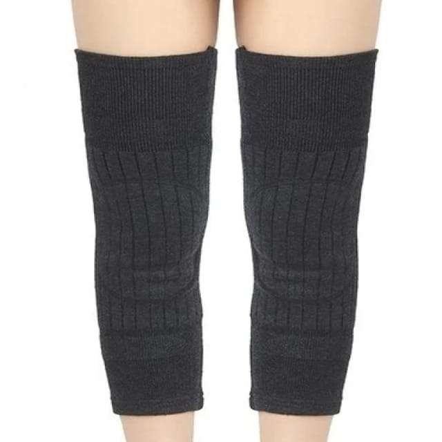 Gray knee-high socks with fur accents worn by a person on a white background