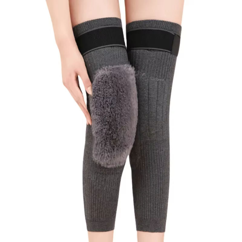 Gray knee-high socks with fur accents worn by a person on a white background